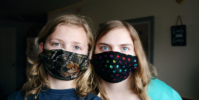 Two woman wearing masks