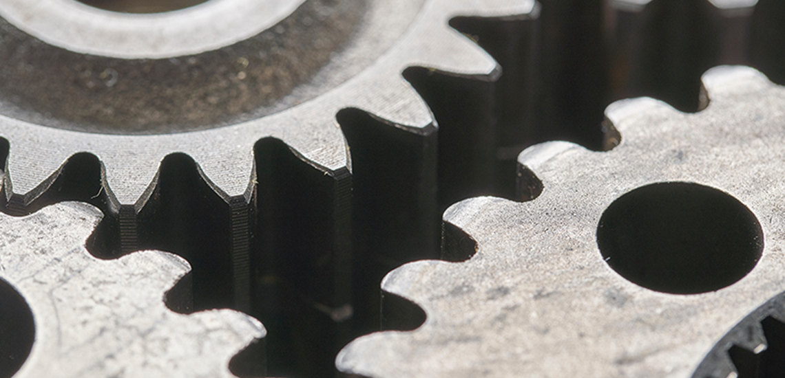Up close image of the teeth of some gears