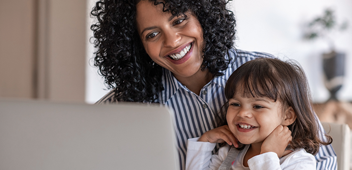 Mom helping daughter with online lessons