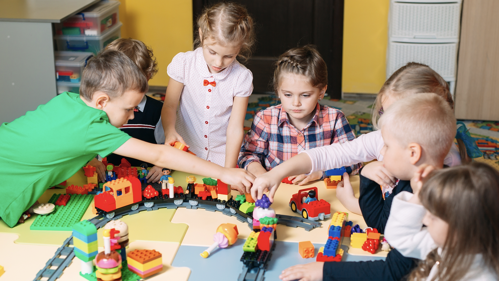 A group of kids playing with Legos