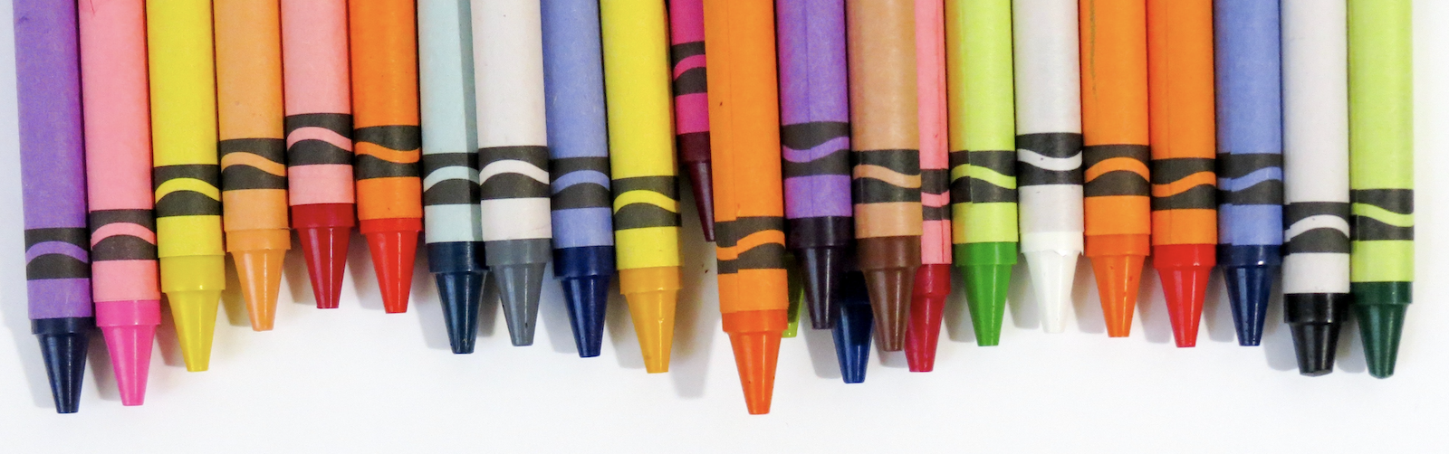 Colored crayons against a white background
